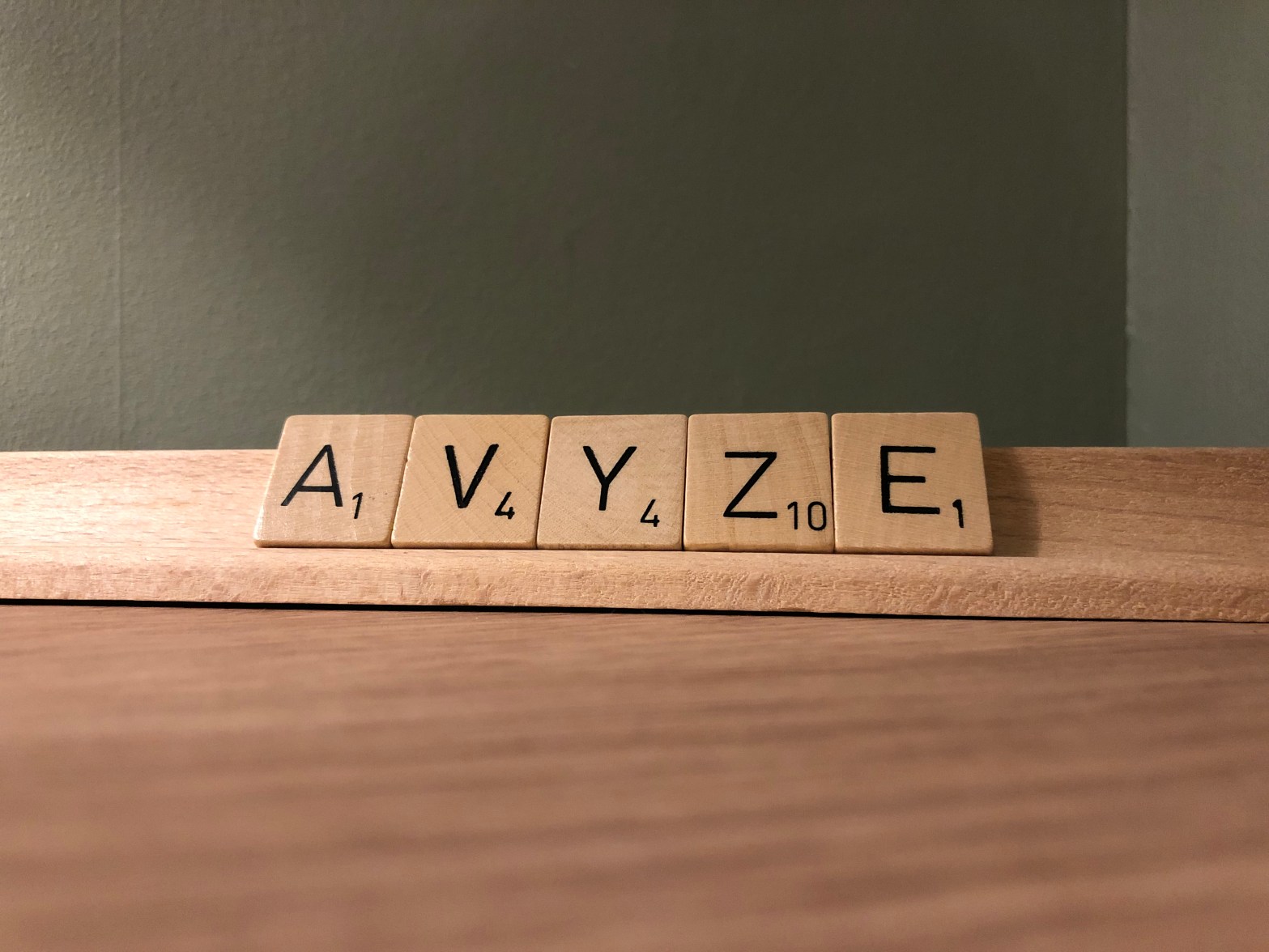 AVYZE spelt with Scrabble letters